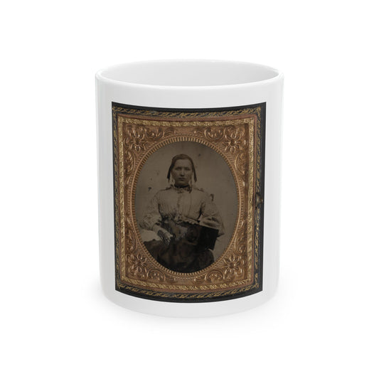 Antique tintype portrait of a seated woman in a pale blouse, set in an embossed brass frame with flower motifs.