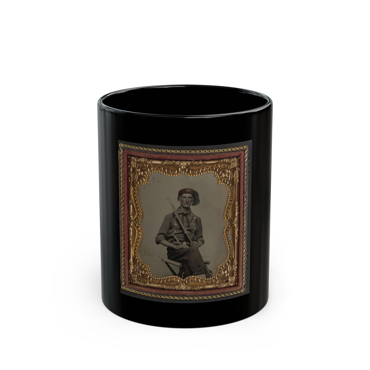 Antique tintype of a seated soldier in a red fez-style cap holding a rifle across his lap, in an ornate gold frame.