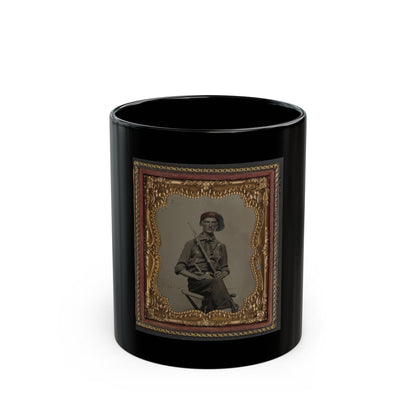 Antique tintype of a seated soldier in a red fez-style cap holding a rifle across his lap, in an ornate gold frame.