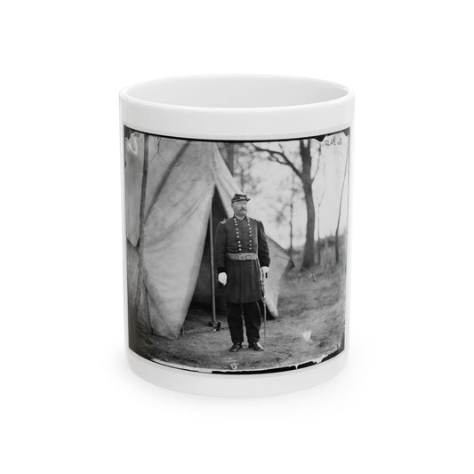 Black and white print of a uniformed officer with a sabre standing beside a canvas tent among bare trees.