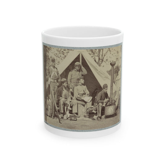 Sepia print showing five soldiers resting around a canvas tent and an iron camp stove, one holding a rifle.