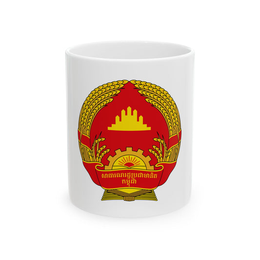 Red and gold national emblem with a wheat wreath, cogwheel, rising sun and a temple silhouette above.