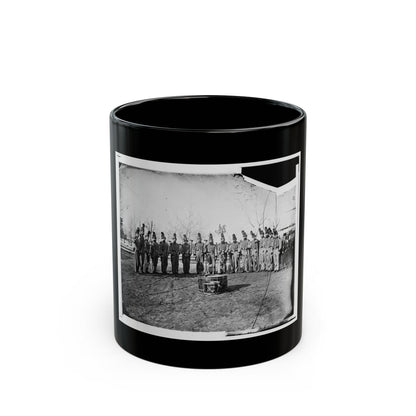 Black and white 1860s view of a uniformed band in plumed hats with brass horns, beside an equestrian statue.