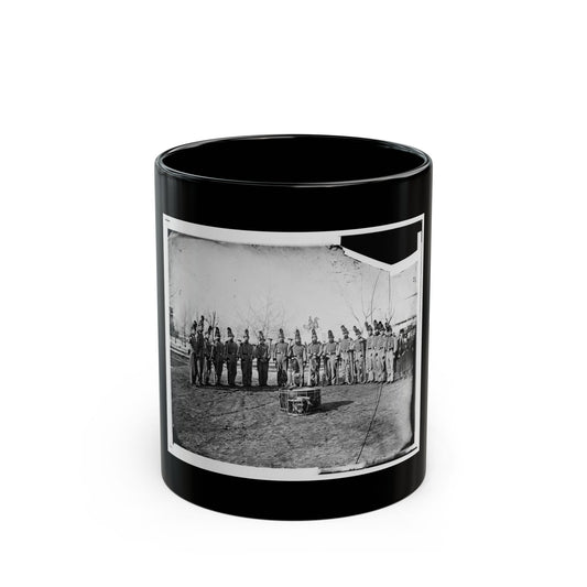 Black and white 1860s view of a uniformed band in plumed hats with brass horns, beside an equestrian statue.