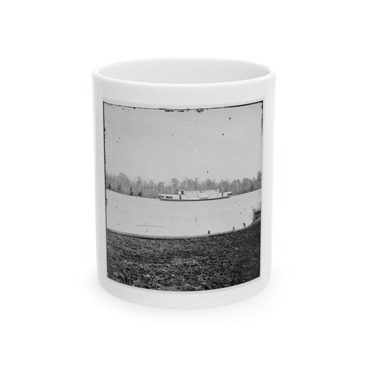 Black and white historical view of a steamboat on a calm river, with leafless trees on the far bank.