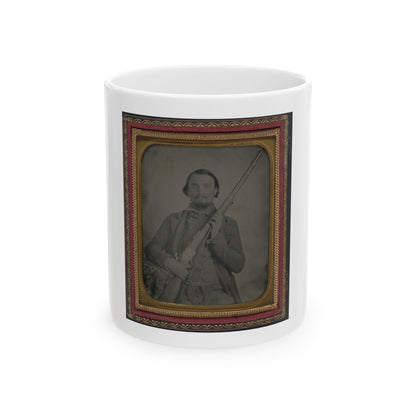 Sepia-toned ambrotype of a bearded man holding a rifle upright, set in a gilt and red velvet case.