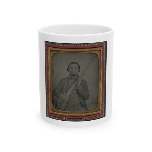 Sepia-toned ambrotype of a bearded man holding a rifle upright, set in a gilt and red velvet case.
