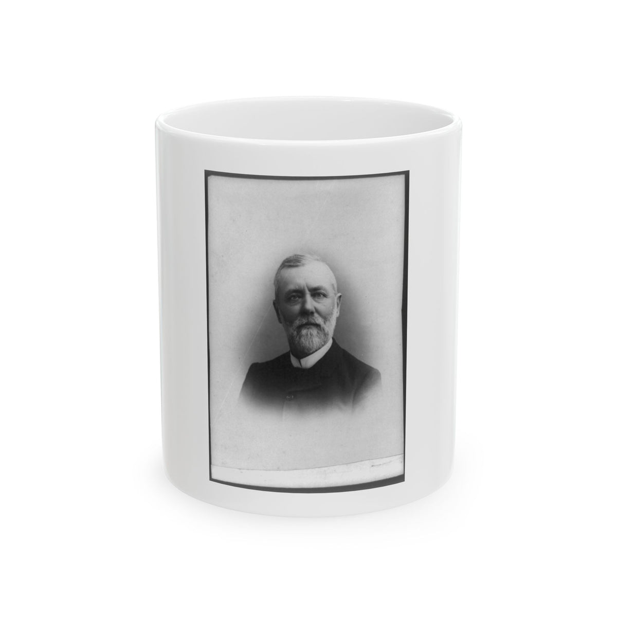 Black and white portrait of an older bearded man in a dark coat and white collar against a pale backdrop.