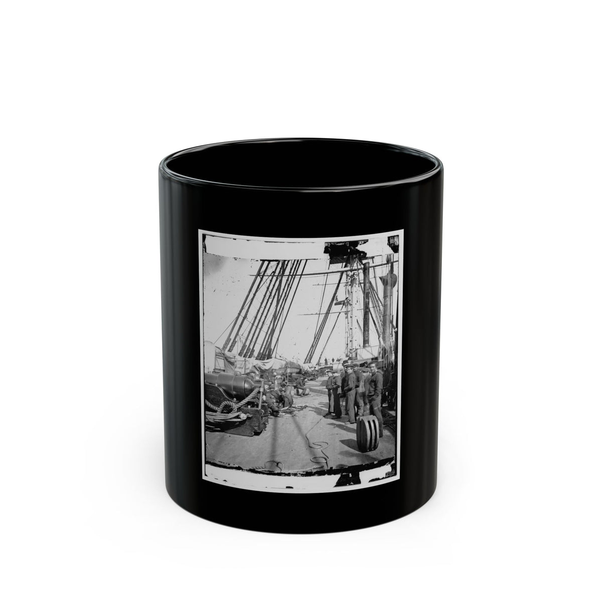Monochrome view of sailors on a wooden warship deck beside a cannon, with coiled ropes and masts.
