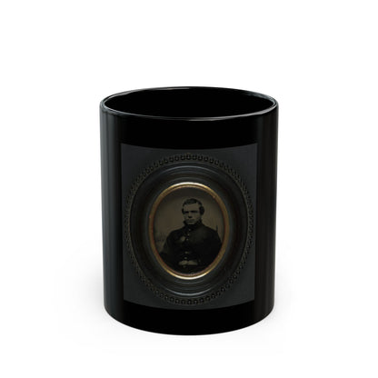 Sepia tintype portrait of a man in a dark coat inside a black oval beaded frame with a gilt inner mat.