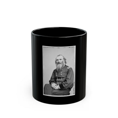 Black and white 19th-century studio portrait of a seated bearded man in a dark military uniform with hands clasped.