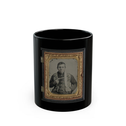 Sepia tintype of a seated young man in a dark coat holding a revolver, framed in an embossed gold case.
