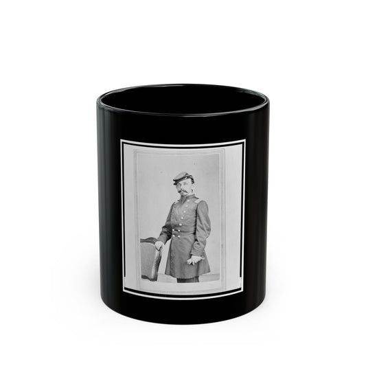 Black and white 1860s studio portrait of a bearded man in a military frock coat and kepi, resting a hand on a chair.