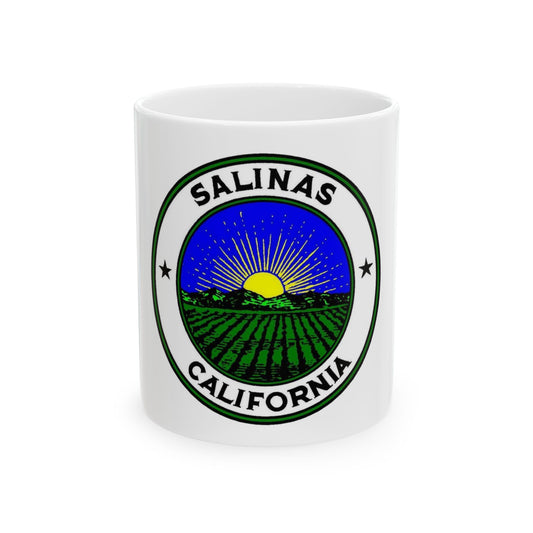Round badge for Salinas, California, with a yellow sunrise over distant hills and green crop rows in farmland.