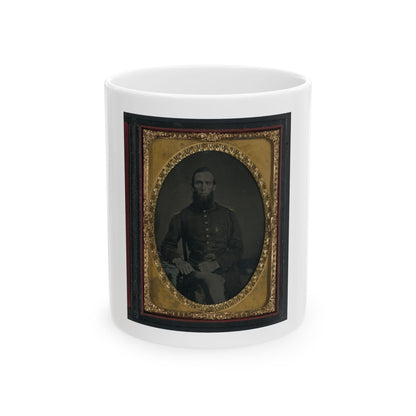 Sepia tintype of a seated bearded soldier in a dark uniform jacket, set in an oval embossed gilt frame.