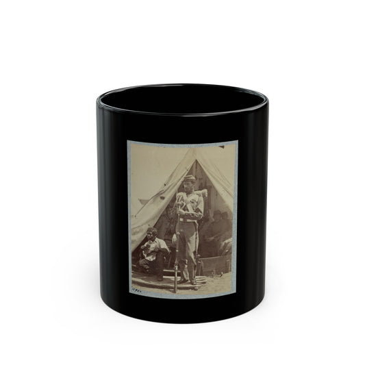 Sepia print showing a soldier with a rifle at a canvas tent entrance, with a seated musician resting inside.