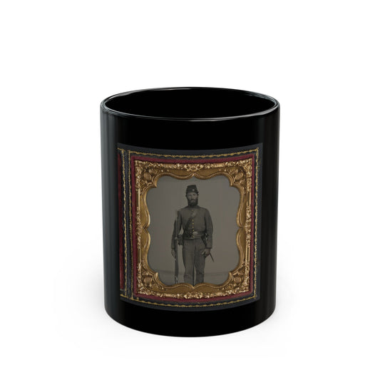 Monochrome tintype of a bearded soldier in a kepi and grey uniform holding a rifle, in a gilt scalloped frame.