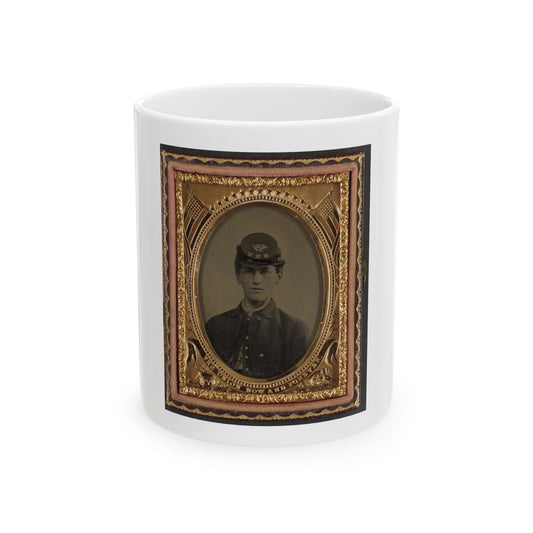Sepia tintype portrait of a young Union soldier in a kepi, set in an ornate gold oval frame with flags and stars.