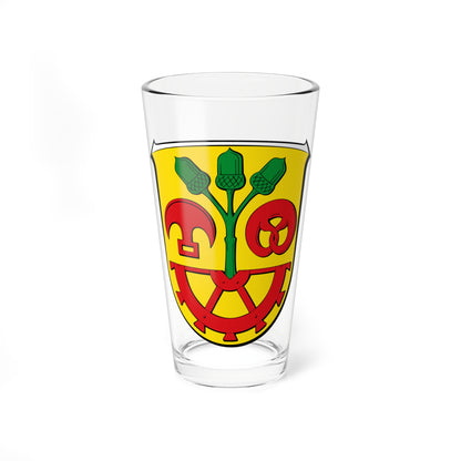 Yellow heraldic shield with a green oak sprig of three acorns above a red wheel, pretzel and helmet.