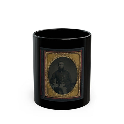 Sepia tintype of a seated bearded soldier in a dark uniform jacket, set in an oval embossed gilt frame.