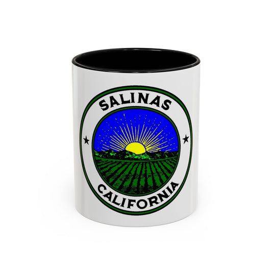 Round badge for Salinas, California, with a yellow sunrise over distant hills and green crop rows in farmland.