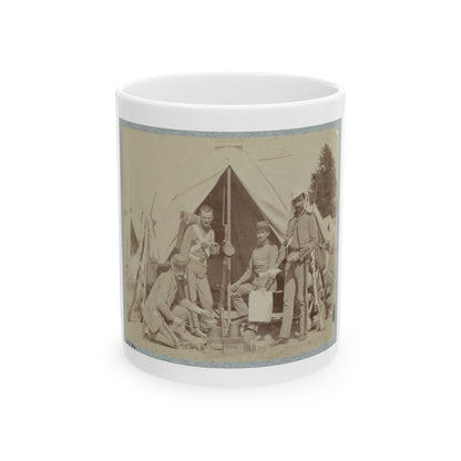 Sepia print showing four soldiers gathered around a cooking fire beside a canvas tent, with rifles stacked nearby.