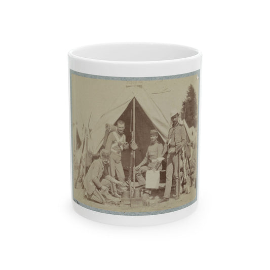 Sepia print showing four soldiers gathered around a cooking fire beside a canvas tent, with rifles stacked nearby.
