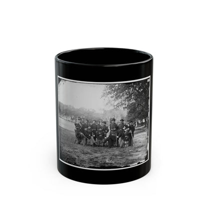 Black and white 1860s group portrait of uniformed officers seated and standing on a grassy lawn under trees.