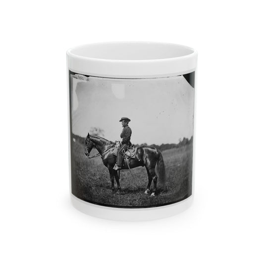 Black and white print of a mounted soldier in a kepi beside a dark bay horse in an open grassy field.