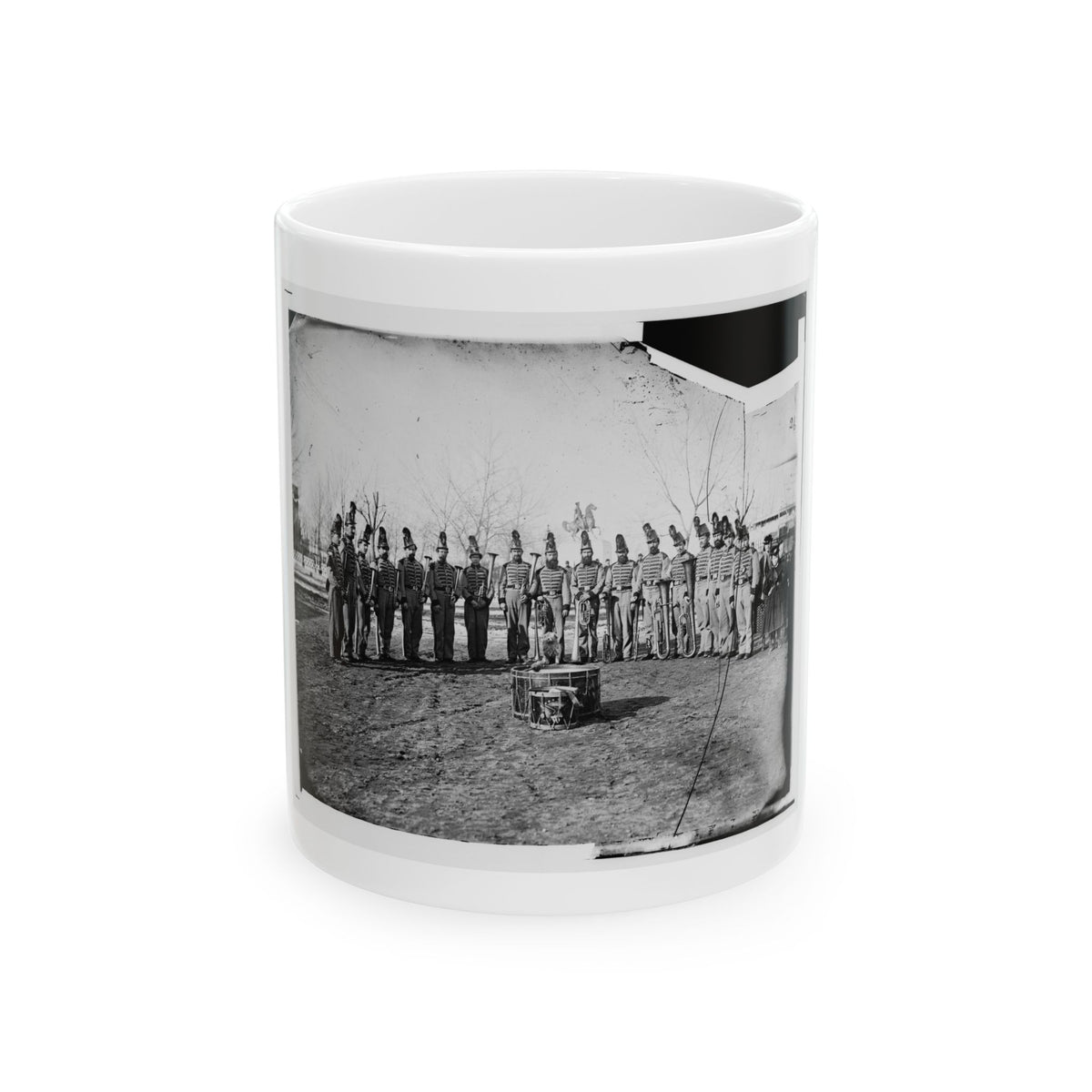 Black and white 1860s view of a uniformed band in plumed hats with brass horns, beside an equestrian statue.