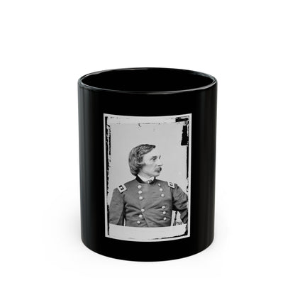 Black and white vintage portrait of a moustached officer in profile, in a double-breasted uniform with high collar.