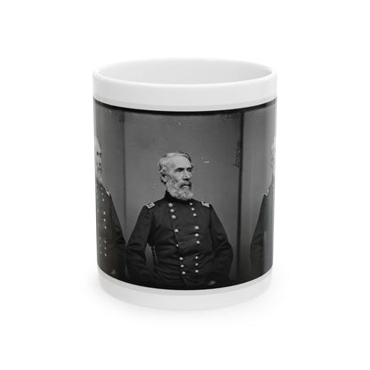 Black and white vintage triptych of one older bearded man in a dark military coat, repeated in three panels.