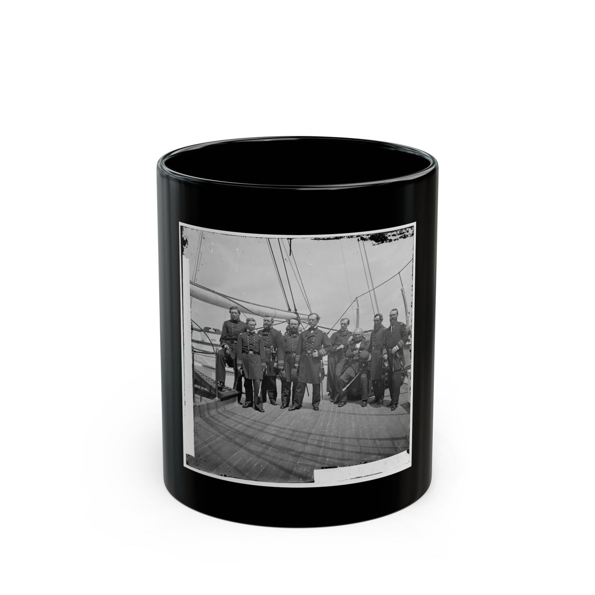 Black and white group portrait of nine uniformed officers, some with swords, on a wooden warship deck.