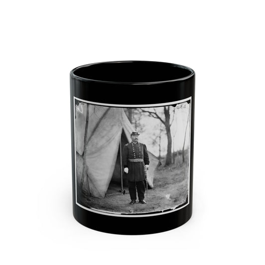 Black and white print of a uniformed officer with a sabre standing beside a canvas tent among bare trees.