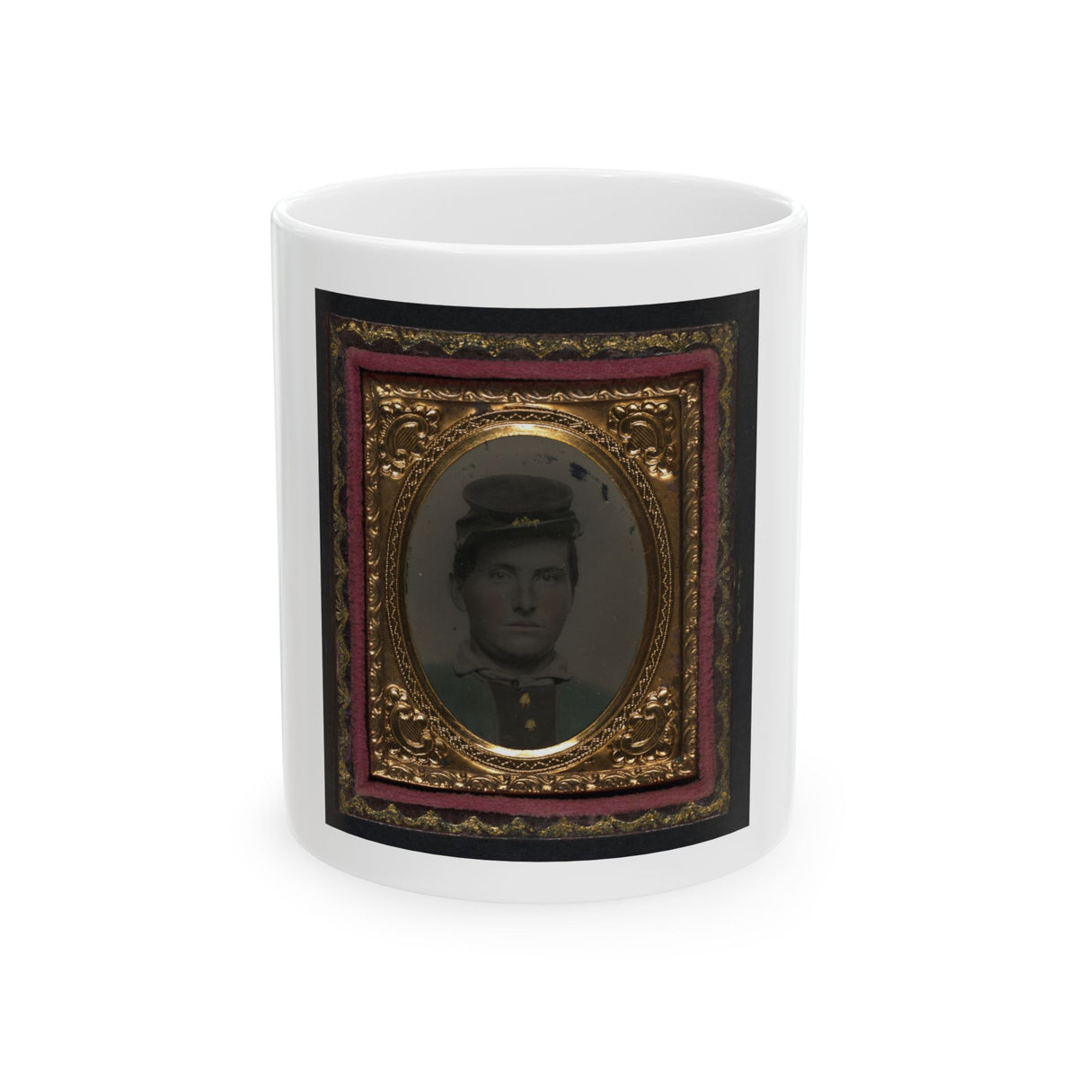 Tintype of a young man in a dark forage cap, shown head and shoulders inside a gilt oval frame with pink velvet.