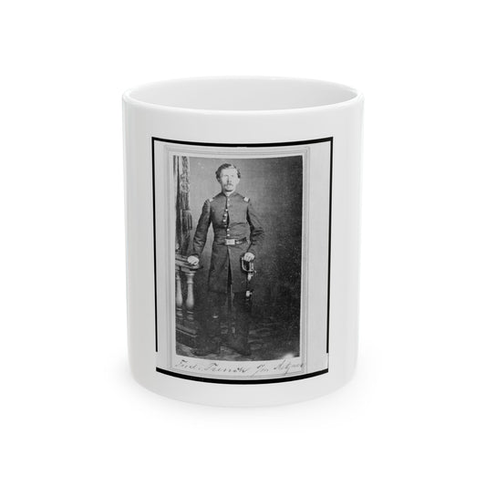 Black and white studio portrait of a standing officer in uniform holding a sword beside a carved pedestal.