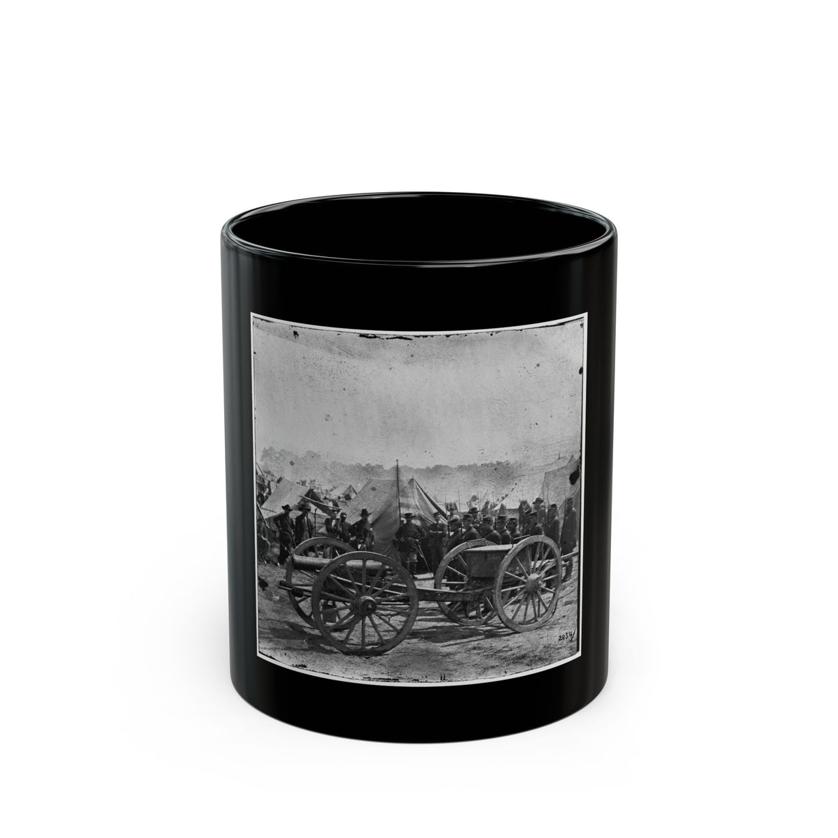 Black and white scene of a field cannon on spoked wheels, with soldiers in a tent camp behind it.