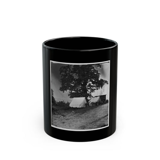 Black and white print of a large oak shading two white canvas tents, with soldiers standing nearby.