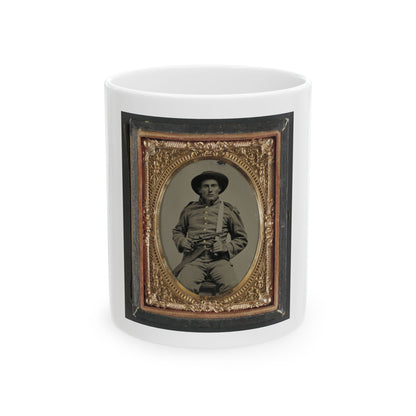 Sepia tintype of a seated soldier in a wide-brimmed hat holding a rifle, set in an ornate oval gold frame.