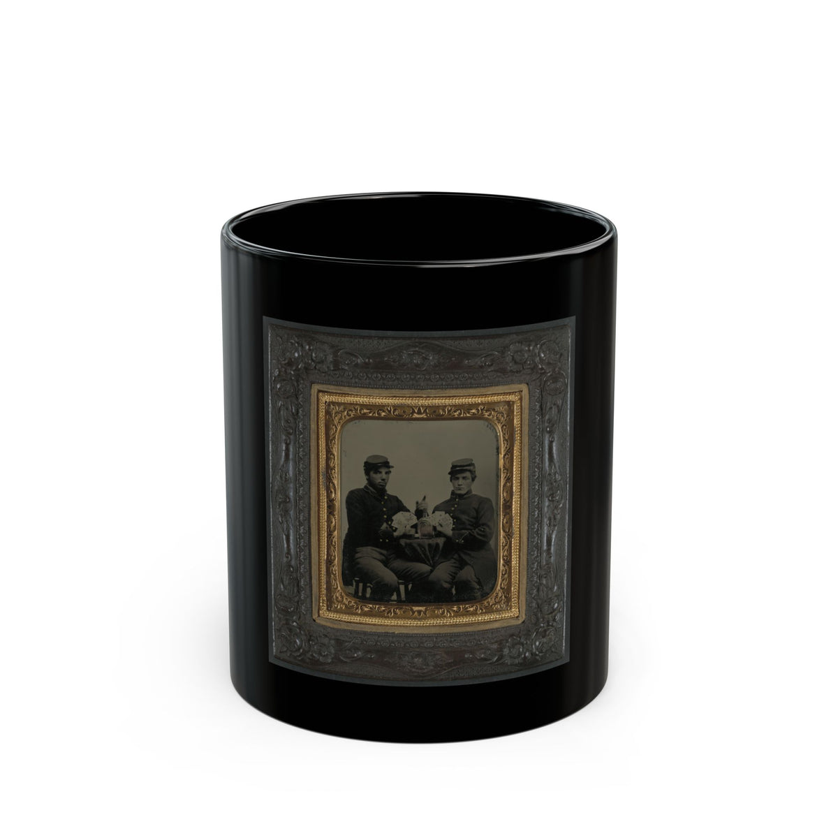 Two seated soldiers in kepi caps playing cards at a table with a bottle, in an antique gilt-framed tintype.