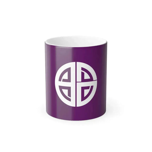 White Japanese mon emblem of geometric patterns in a segmented circle on a dark purple background.