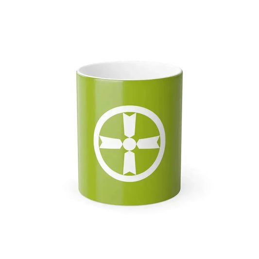 White ring enclosing a four-armed ribbon-like cross and a central disc, on a flat lime green field.