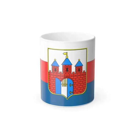 Tricolour flag of white, red and blue with a heraldic shield showing a red brick castle with blue-roofed towers.