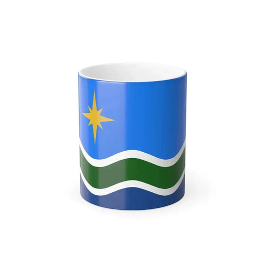 Gold eight-pointed star above wavy white-edged bands of green and navy on a bright blue field.